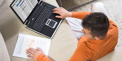 Photo of a man studying on a laptop