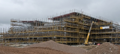 A building with scaffolding all around in the process of being built