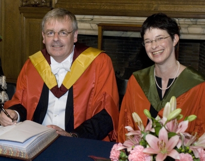 A man and woman in acedemic robes