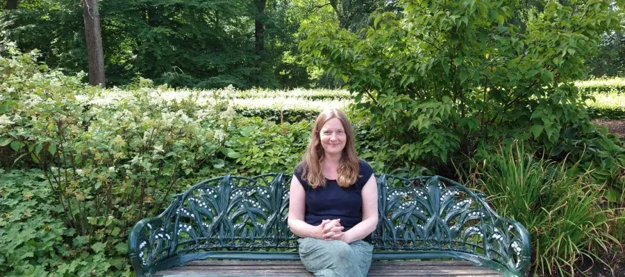 Dr Deborah Hoyle sitting on a park bench