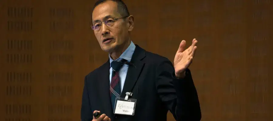 A man giving a talk in a lecture theatre