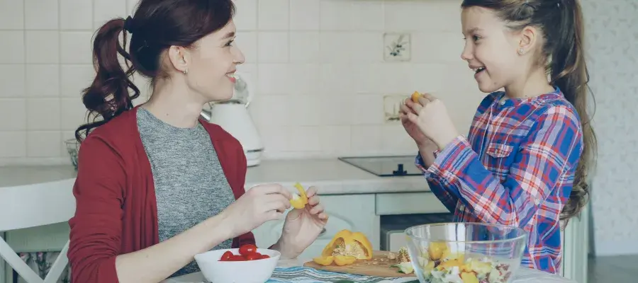 Mother and daughter in a kitchen, preparing food