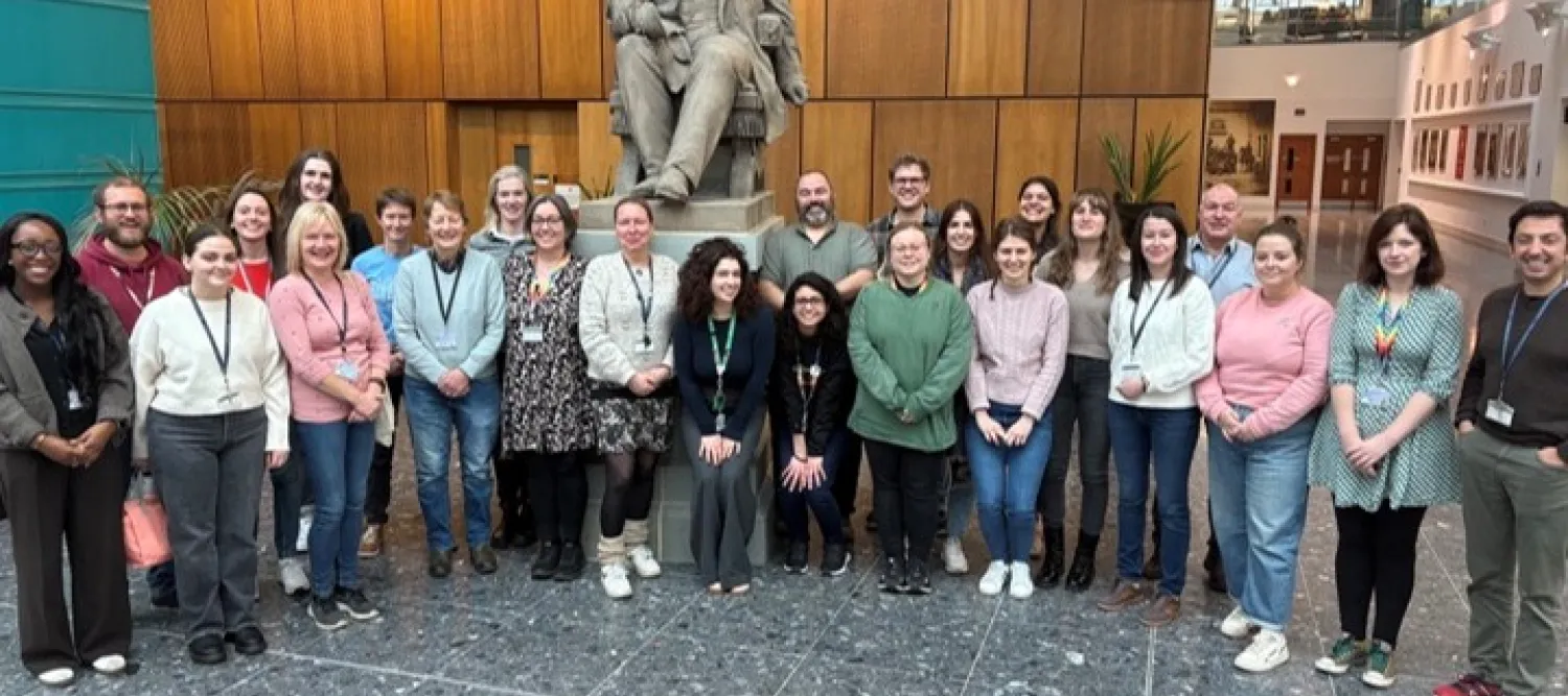 large group of adults stood in a semi circle