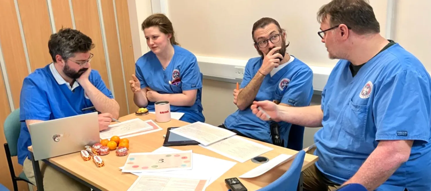 Clinical veterinary staff working in a small group