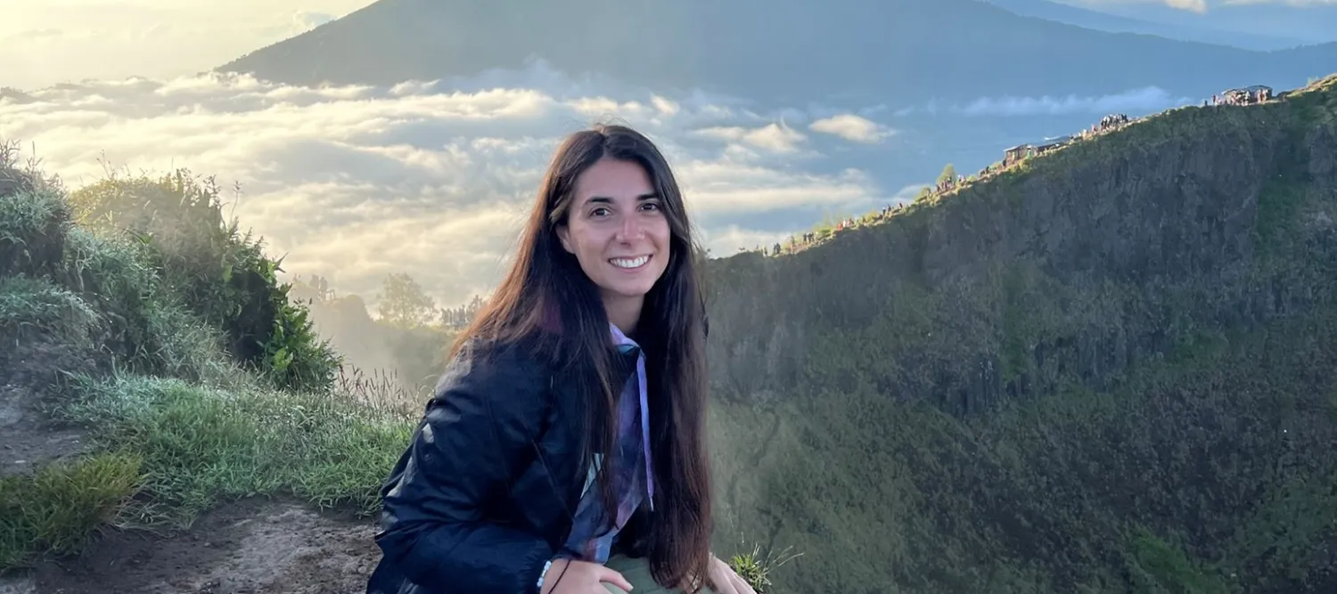 Francesca on top of a hill with a cloud inversion visible in the background
