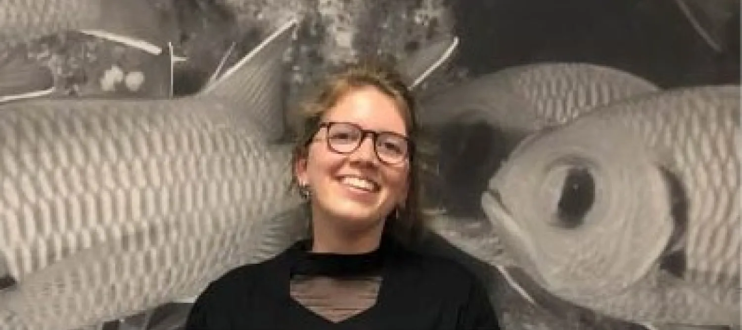 Kaylee in front of some fish