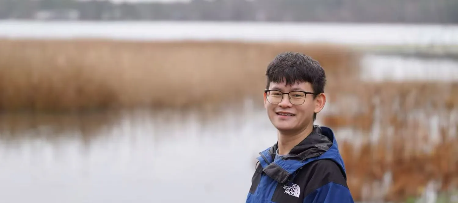 Jiaqi next to water