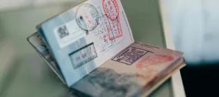 An open passport with various stamps