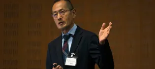 A man giving a talk in a lecture theatre