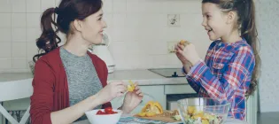 Mother and daughter in a kitchen, preparing food