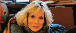 image of woman with blond mid-length hair looking into the camera and smiling