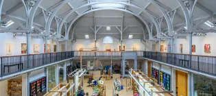 The interior of Dovecot from on high showing a large space and buzzing activity below