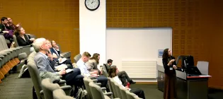 Audience listening to a speaker during the symposium held in the Roslin auditorium