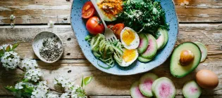 Plate of vegetables, pasta and hard-boiled eggs.