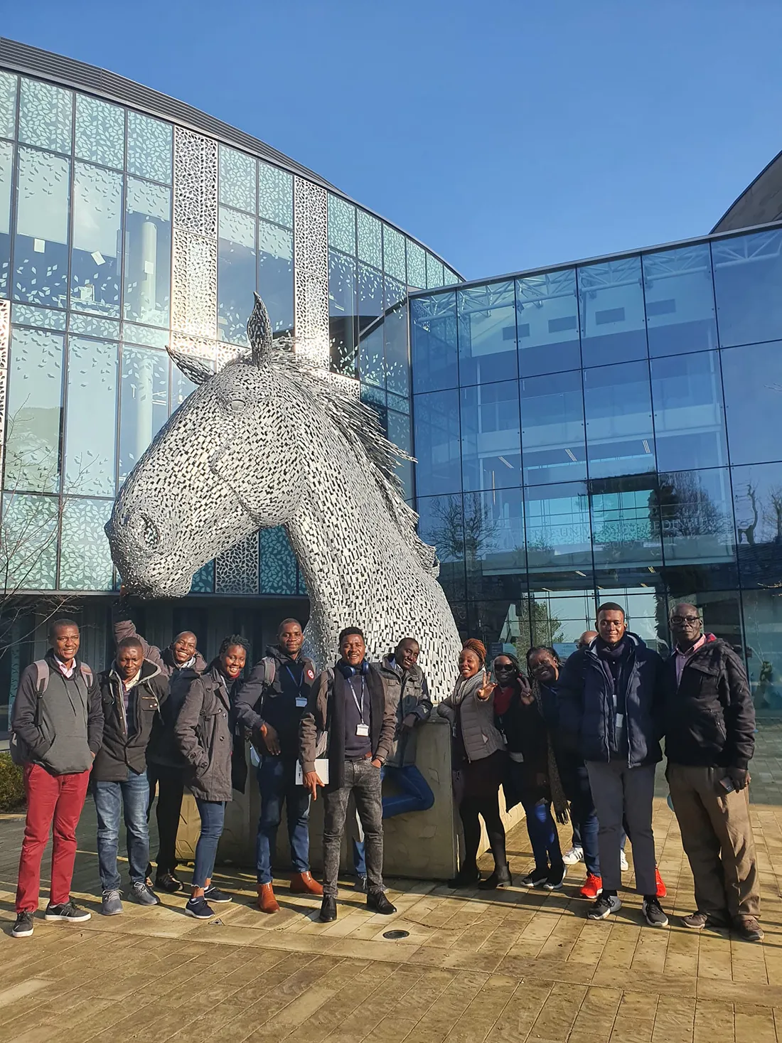 The Fleming Fellows cohort on Easter Bush Campus, standing in front of a statue of a horse.