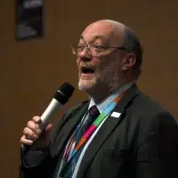 Prof Bruce Whitelaw speaking, holding a microphone