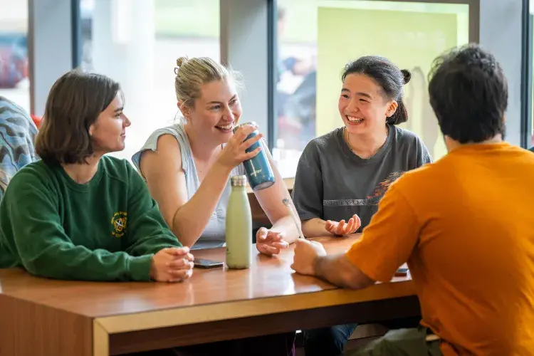 Students sitting round a table talking