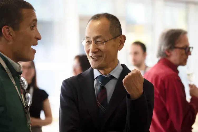 Prof Shinya Yamanaka talking to a member of the audience during the drinks reception