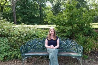 Dr Deborah Hoyle sitting on a park bench