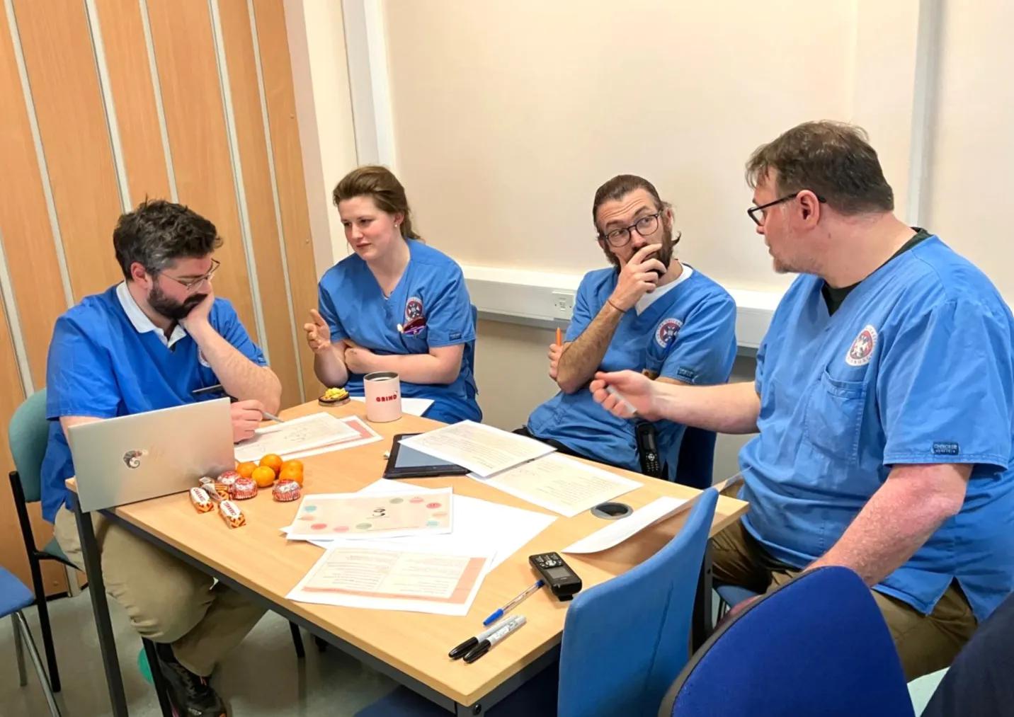 Clinical veterinary staff working in a small group
