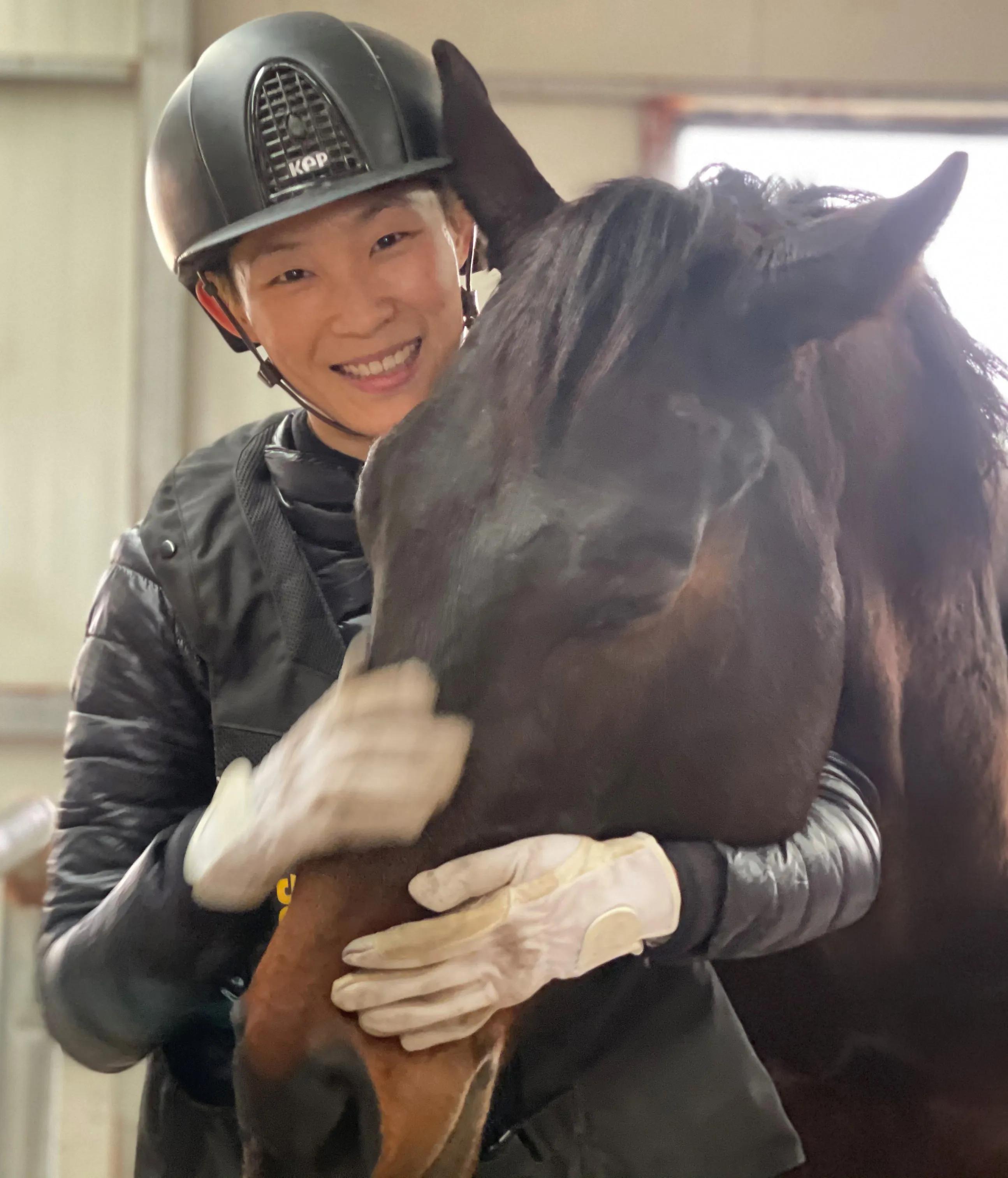 Student hugging a horse