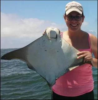 PhD student Helen Weber holding a cownose ray