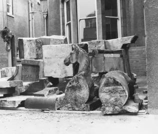 An equine sculpture split into two halves before its restoration.
