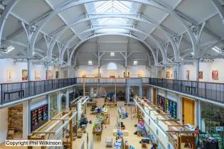 The interior of Dovecot from on high showing a large space and buzzing activity below