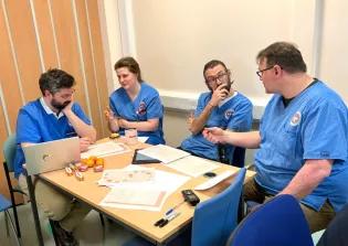 Clinical veterinary staff working in a small group