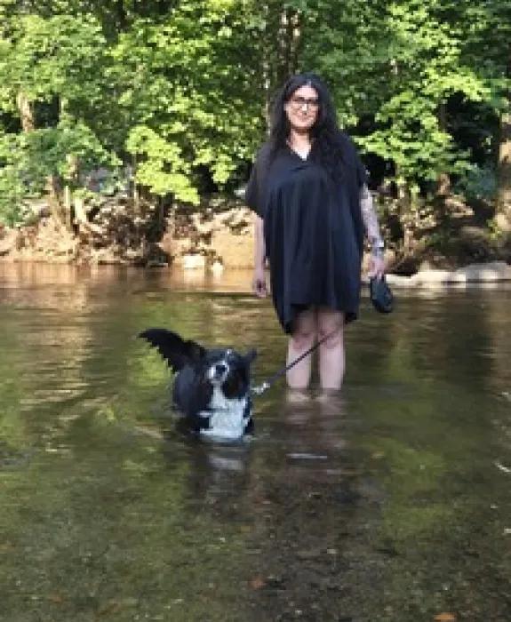 Dom in a river with her dog