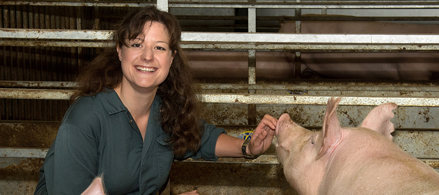 Christine Burkard with a pig