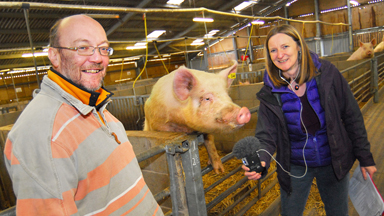 Caz Graham and Moira Hickey with a pig on a farm