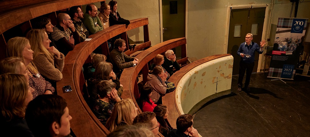 Dick Vet alumni listen to lecture in wooden tiered lecture theatre