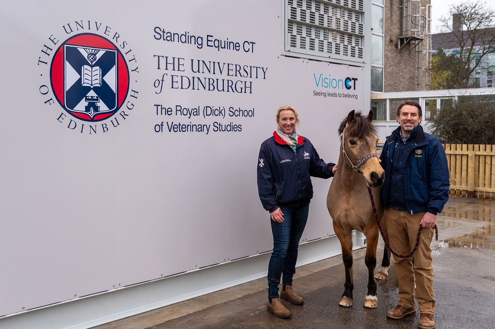 two pwople and a horse standing in front of a large container with details of contents - a standing Equine CT - written on the side