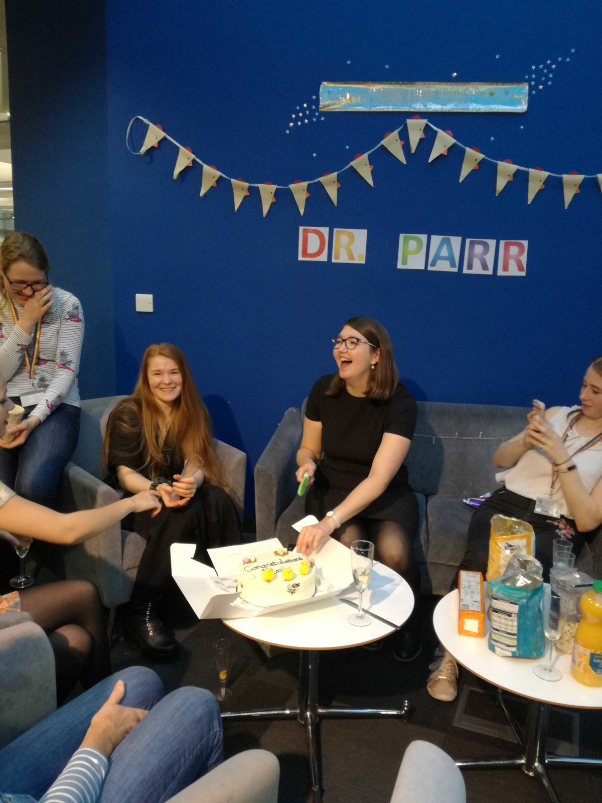 Emily cut the cake at her viva, 2019