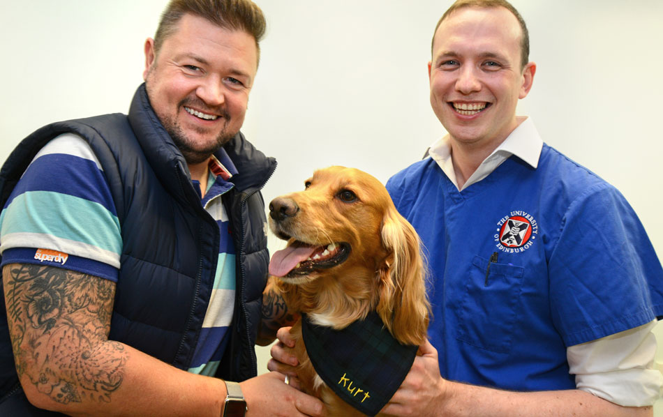 vet with a client and their pet dog