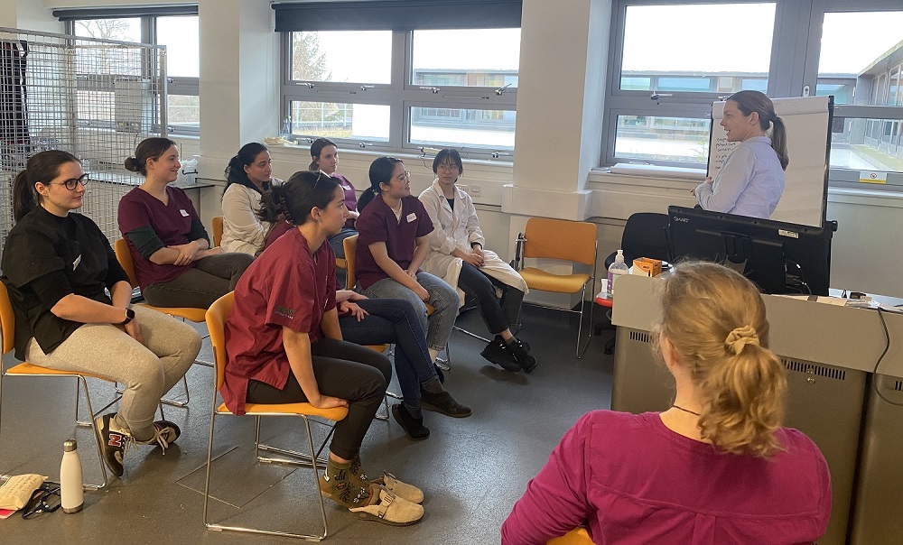 group of vet students discussing something with a lecturer