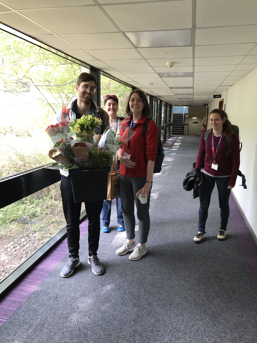 Jess and colleagues holding flowers