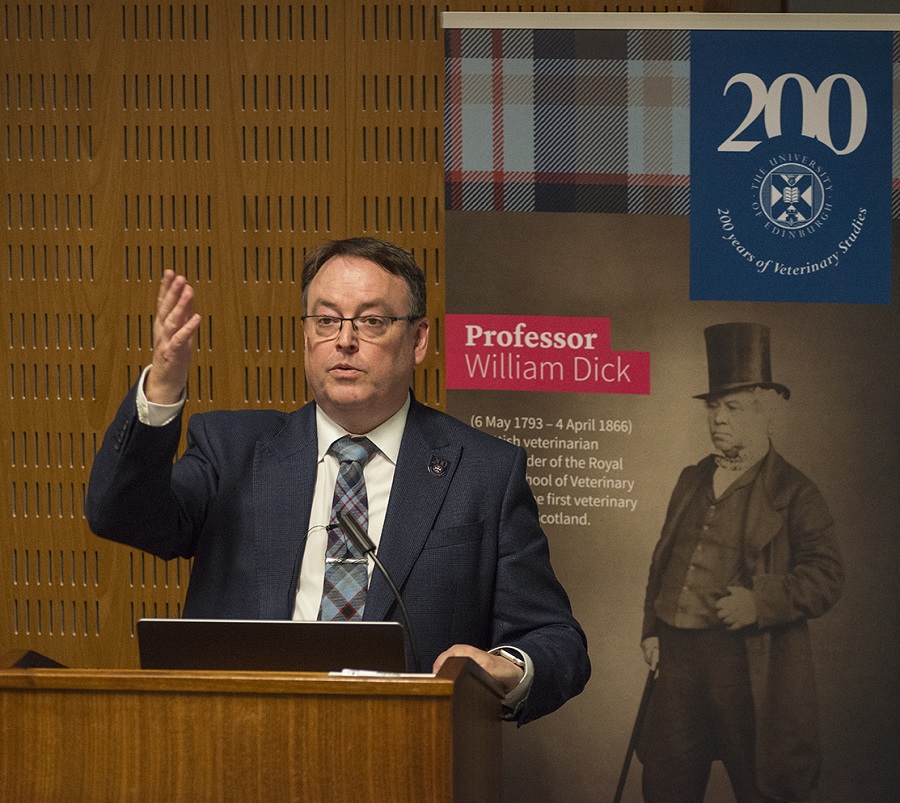 Professor Argyle standing at lectern talking