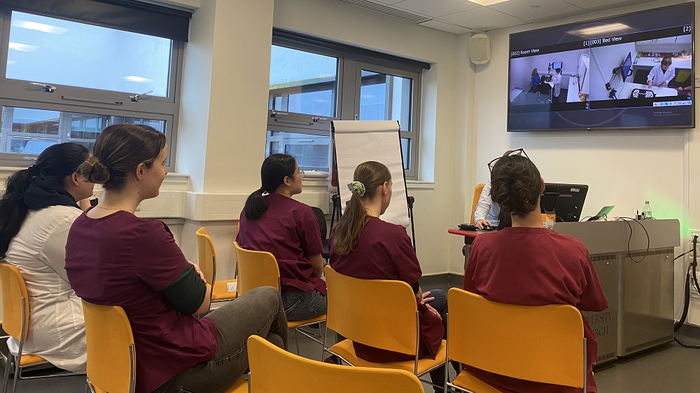 group of vet students watching other students in simulation lab via video link 