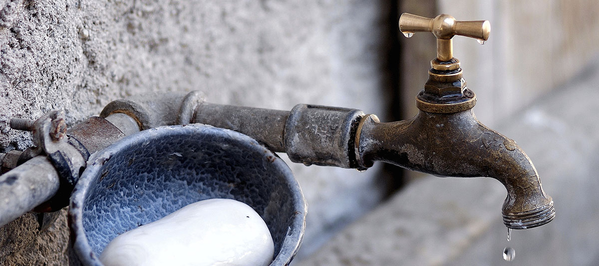 Tap and soap on stone wall