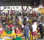 Panoramic shot of people in a market hall